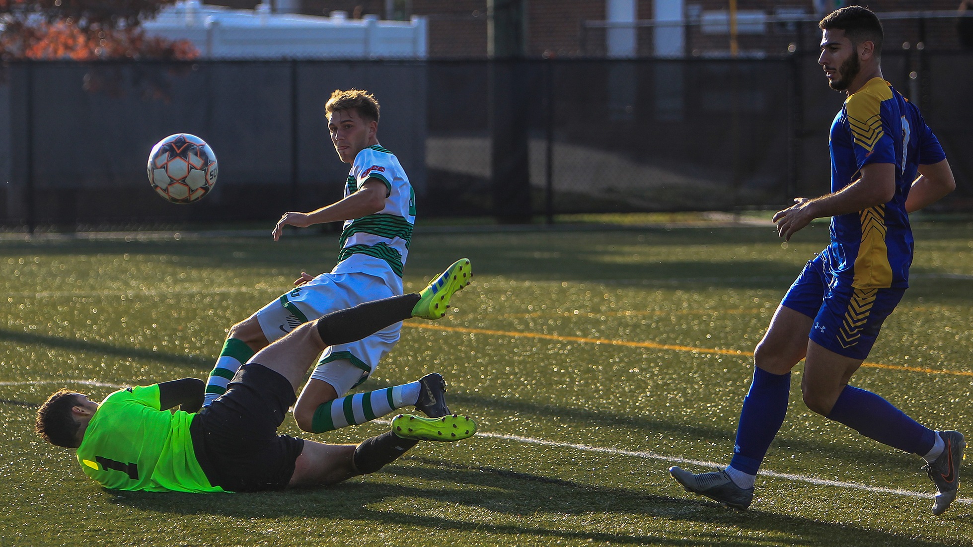 Wilmington University player Lorne Bickley (top) scores a goal against Concordia College goalkeeper Michael Varin  as Concordia?s Luca Wanna (R) follows the play during the first round of the CACC tournament at the Wilmington University Athletic complex in Newark, Delaware, November 11, 2019. Tim Shaffer Photo.