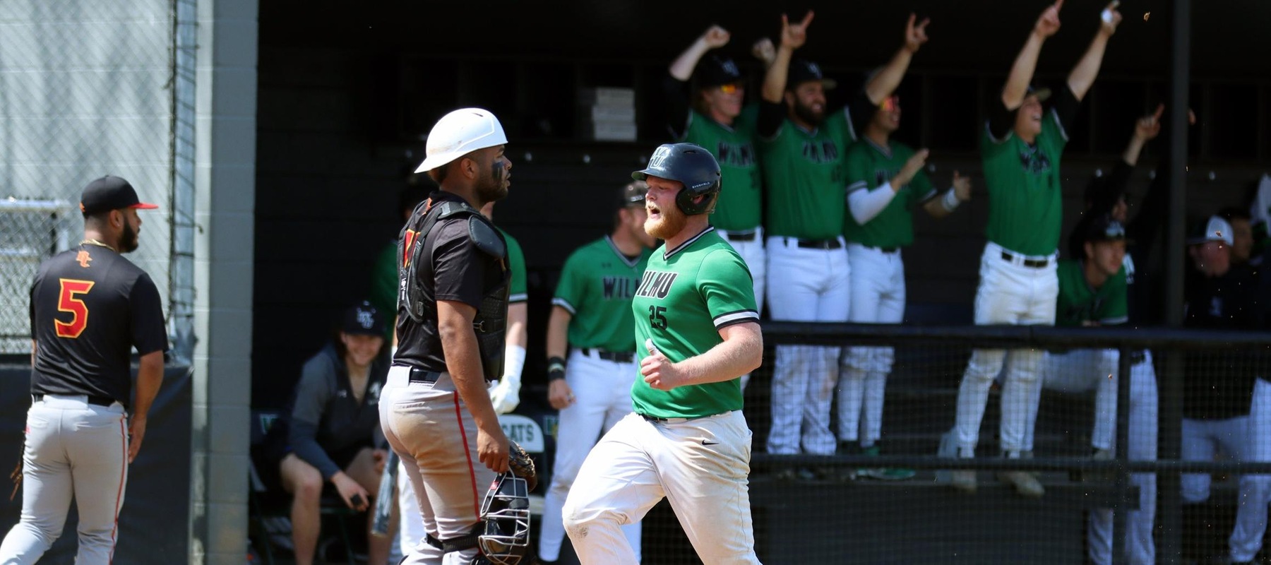 Photo of the team celebrating as Eddie Parry scores off a Shawn Haut double against Bloomfield. Copyright 2023; Wilmington University. All rights reserved. Photo by Dan Lauletta. April 5, 2023 vs. Bloomfield.