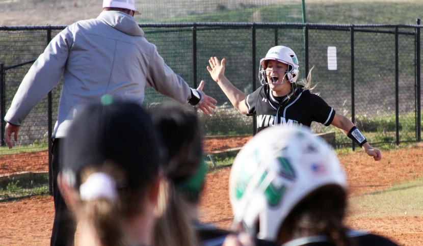 Copyright 2018; Wilmington University. All rights reserved. Photo of Keara McCarthy after hitting her three-run home run against MSU Mankato. She went 3-for-6 with four RBI on Thursday. Taken by Owen Groff (son of assistant coach Rich Groff, also pictured). March 8, 2018.
