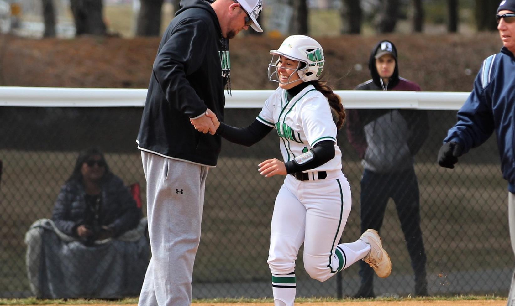 Copyright 2019; Wilmington University. All rights reserved. Photo of Annie Davila greeting assistant coach Rich Groff after one of her two home runs on Wednesday. Photos by Keara McCarthy. March 13, 2019 vs. Shippensburg.