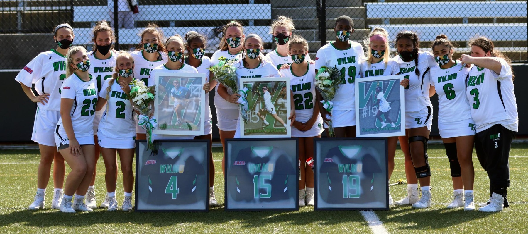 Photo of the team with the three seniors following the game against Holy Family. Brooke Siebert (15), Maris Allen (4), and Casey Johnson (19). Copyright 2021; Wilmington University. All rights reserved. Photo by Erin Harvey.
