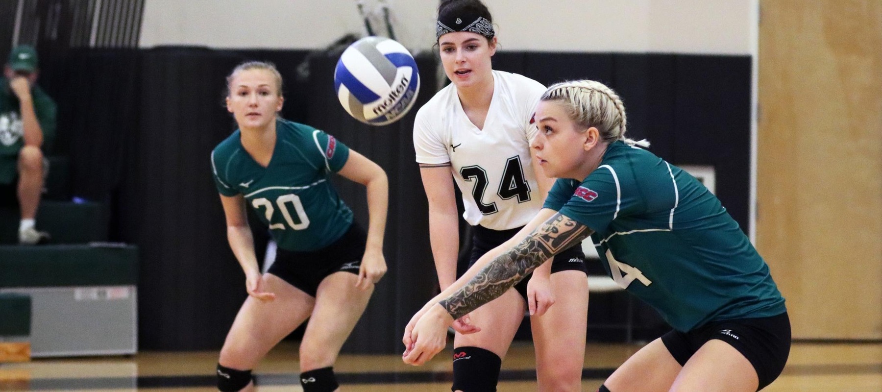 Photo of Mandy Behiels receiving a serve against Nyack with Elly Collins (24) and Genevieve Hughes (20) looking on. Copyright 2021; Wilmington University. All rights reserved. Photo by Dan Lauletta.